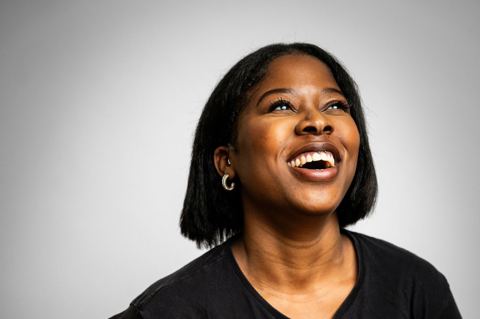 Comedian Honey B laughing on stage