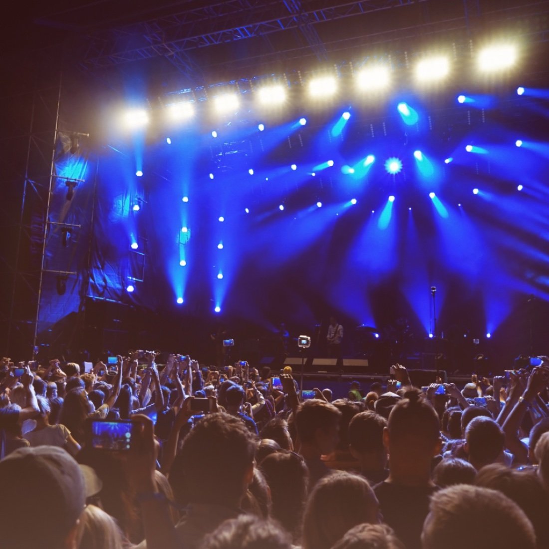 A packed crowd enjoying live entertainment under the stage lights at a KCD Entertainment event